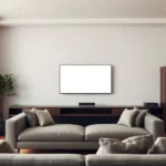 sala de estar com televisão ligada e sofá em frente